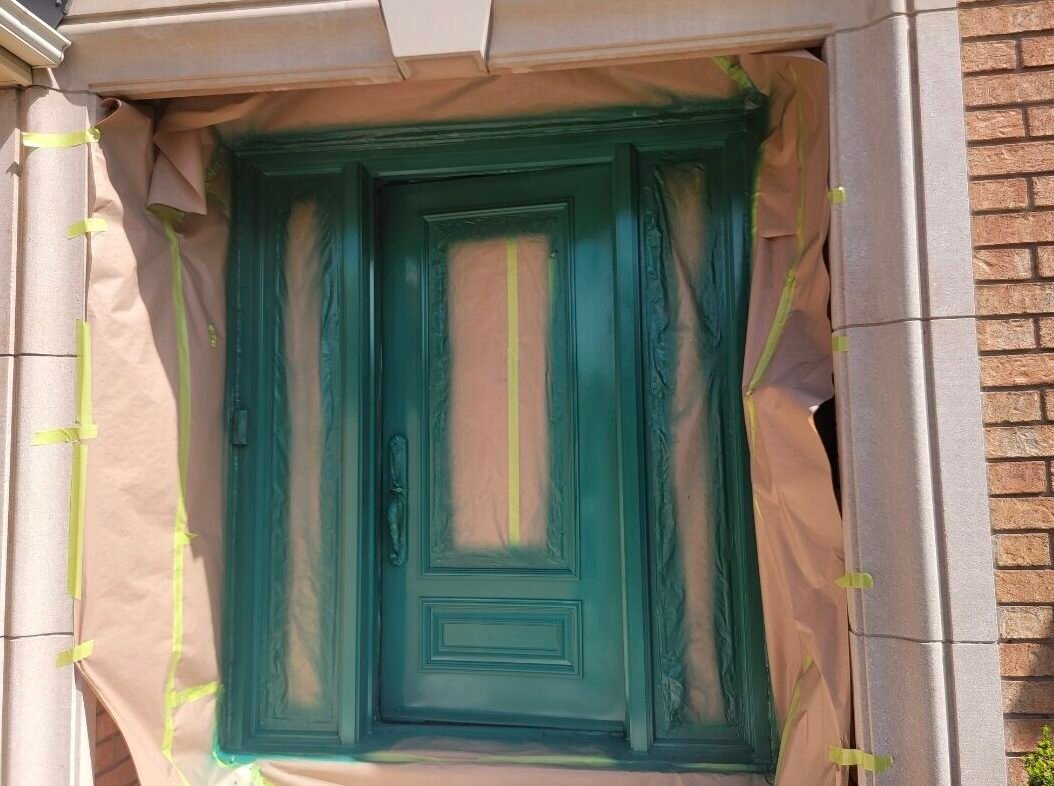 Front door prepared and painted by soca services for a exterior painting project