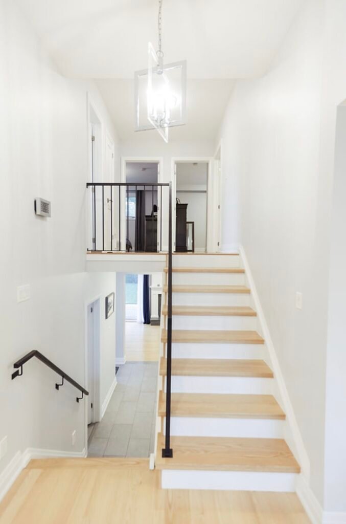 1000073762 a staircase with a black railing staining painting