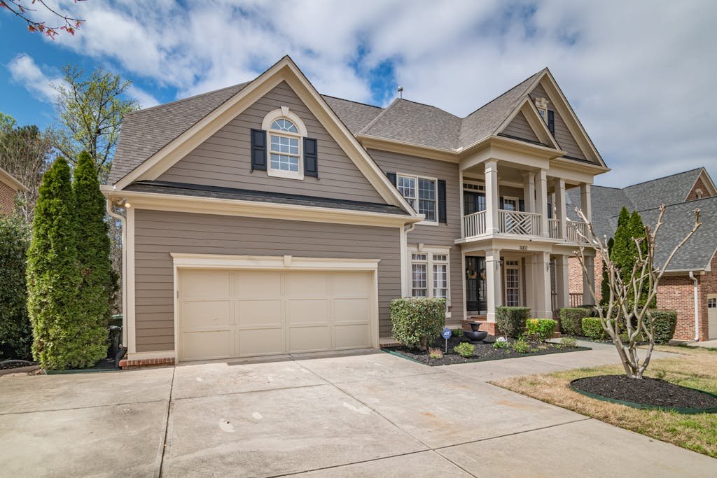 A beautiful suburban home with a spacious front garage and aluminum painting by soca services