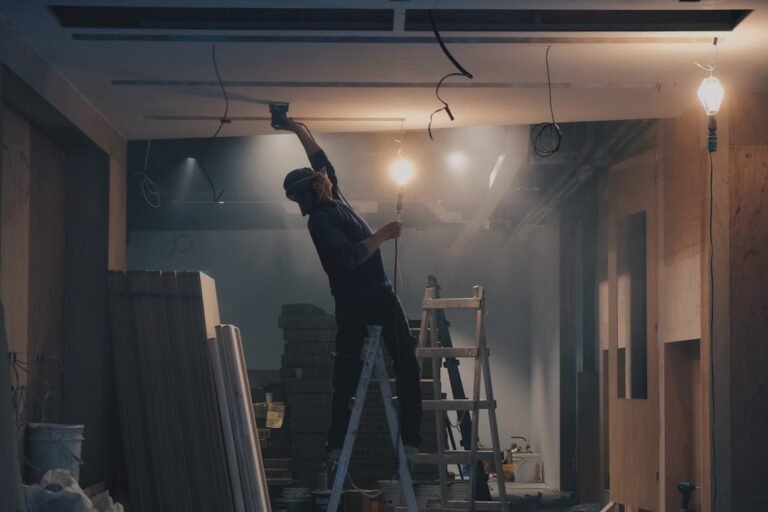 Professional contractor working on ceiling renovation with ladder in residential home interior. Photo by Unsplash