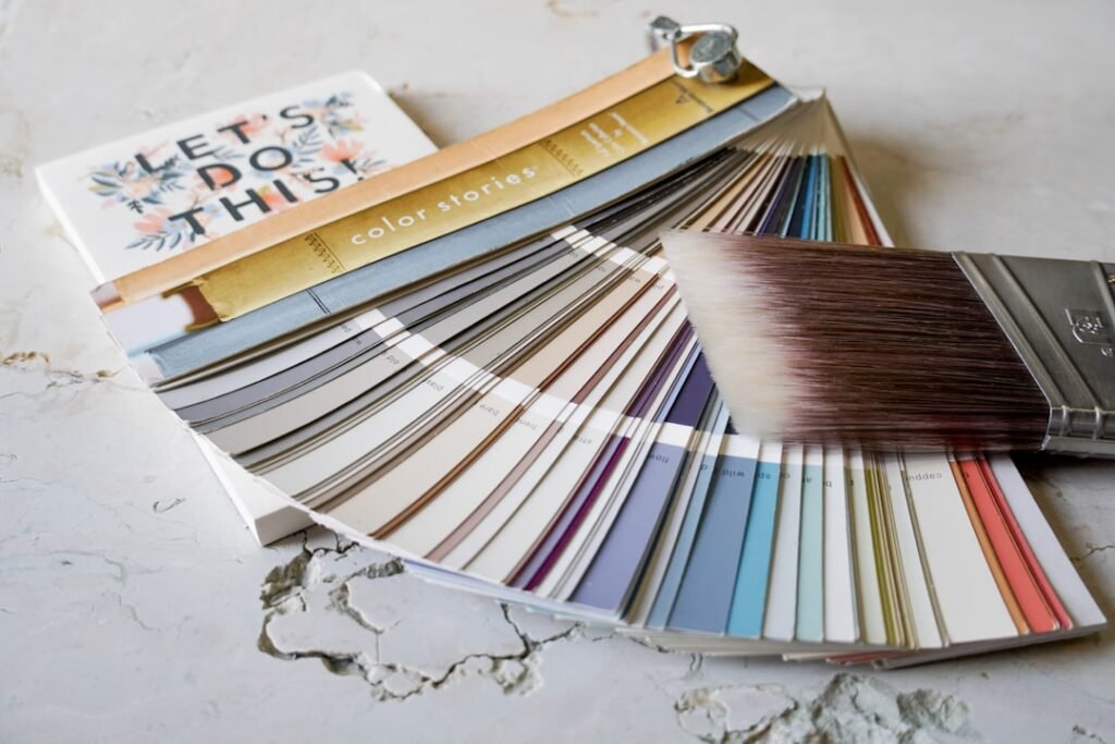 Paint color samples and brush showing different finish options for cabinet painting