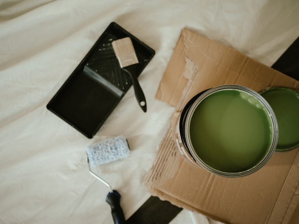 DIY painting supplies including paint can and brushes for cabinet painting project