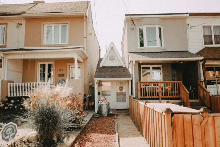 Toronto houses showing different exterior paint colors and styles, representing house painting cost considerations. Photo by Vitaly Mazur on Unsplash